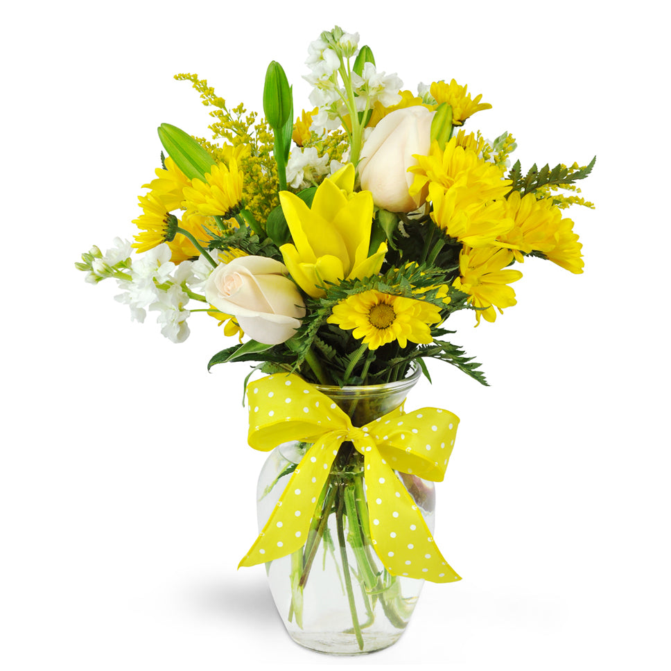 Smile a Mile Daisy Vase™ - Standard. Yellow lilies and daisies are arranged with cream roses and topped off with a bright ribbon.