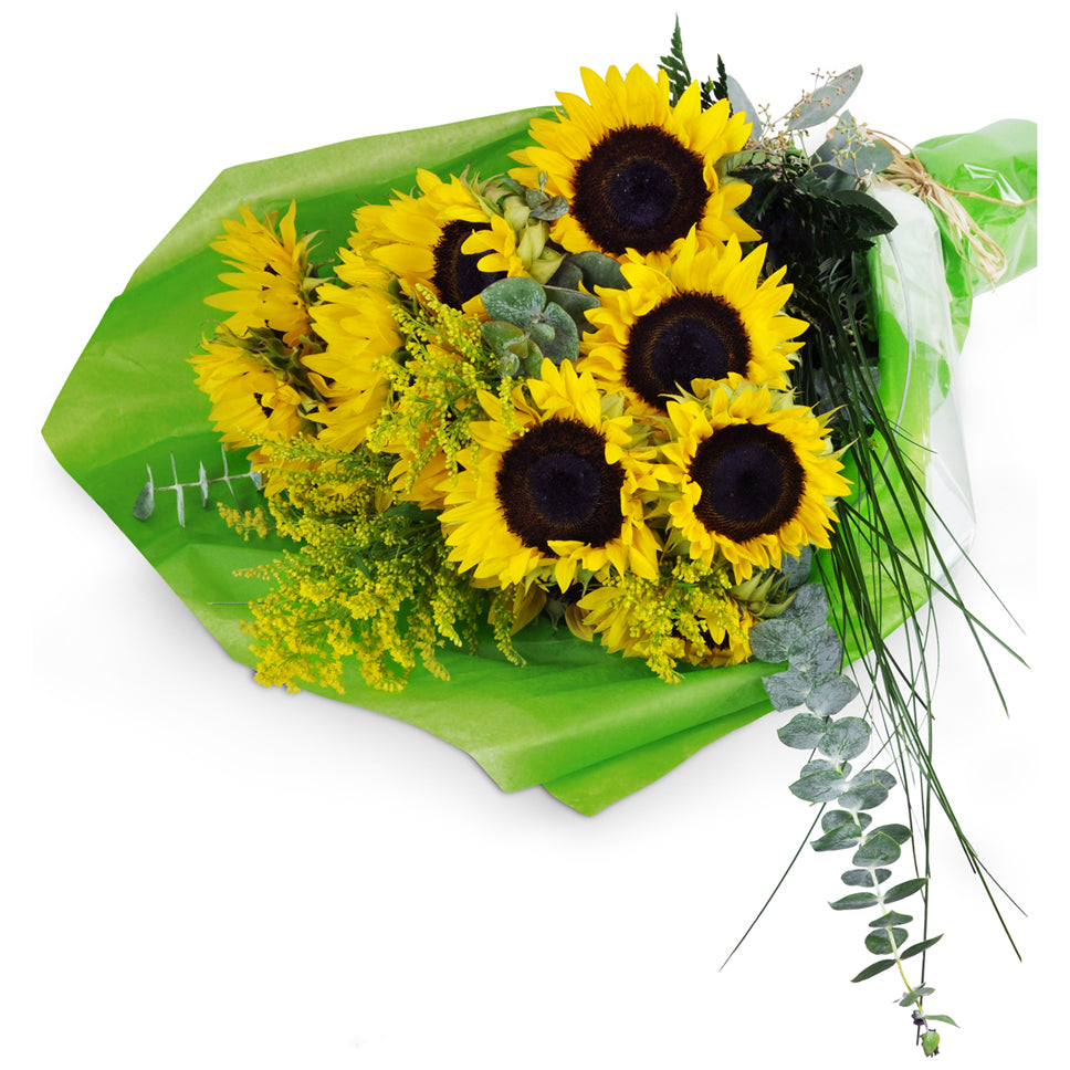 Armful of Sunshine flower bouquet. Sunflowers, eucalyptus, and assorted greens are freshly wrapped and ready to be placed in a vase.