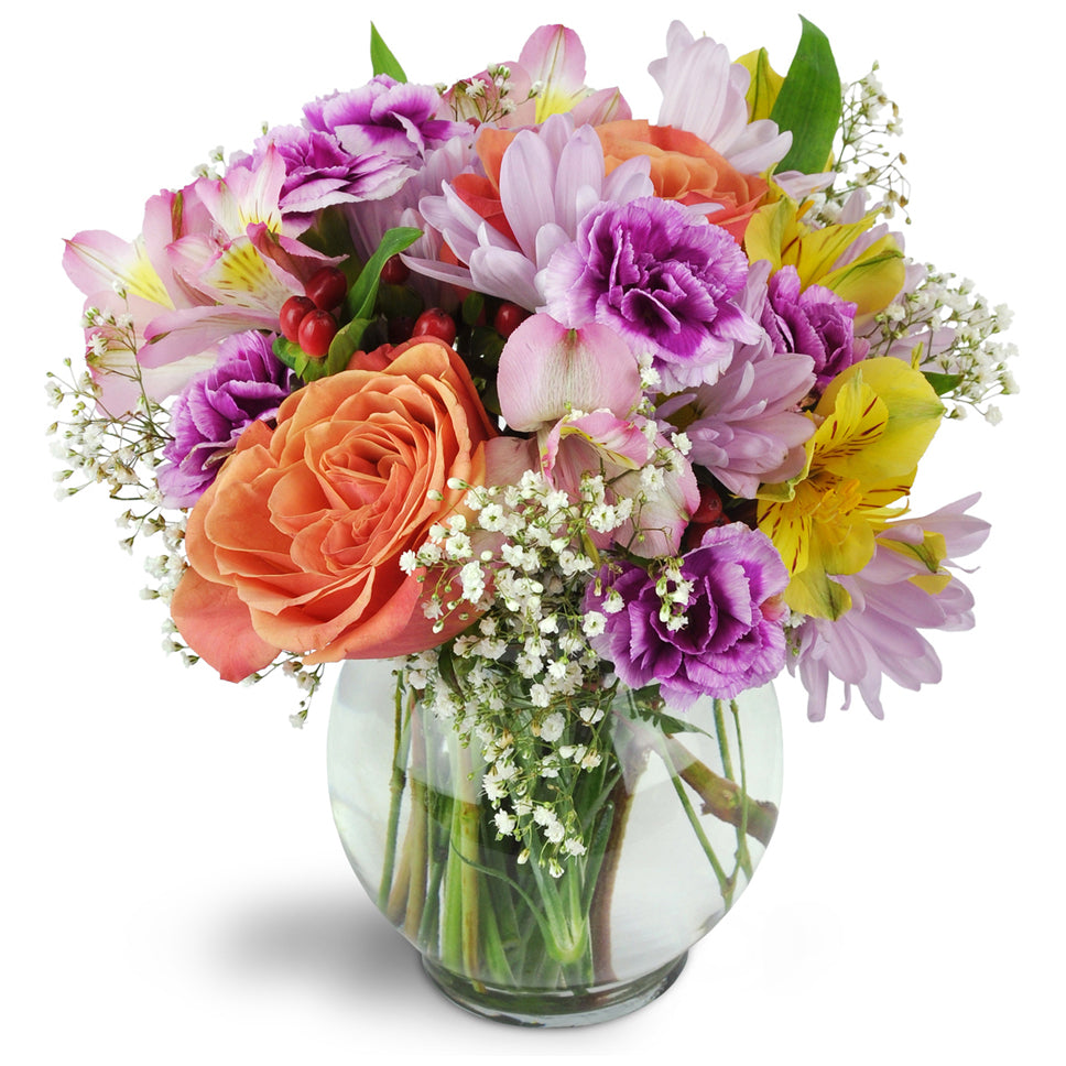 Cute as a Button!™. Delightful orange roses, yellow and pink Peruvian Lilies, miniature carnations, and more are arranged in a cheerful color palette.