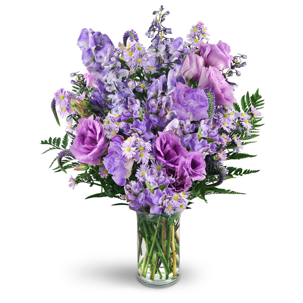 Purple Passion - Premium. Monk's hood, delphinium, veronica, purple lisianthus, Monte Cassino asters, and more are delightfully arranged in a classic glass vase.