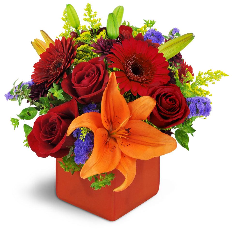 Fruit of the Bloom™ - Premium. A colorful mix of mini Gerbera daisies, Asiatic lilies, and chrysanthemums are accented with bupleurum, hypericum berries, purple statice, and orange waxflower.