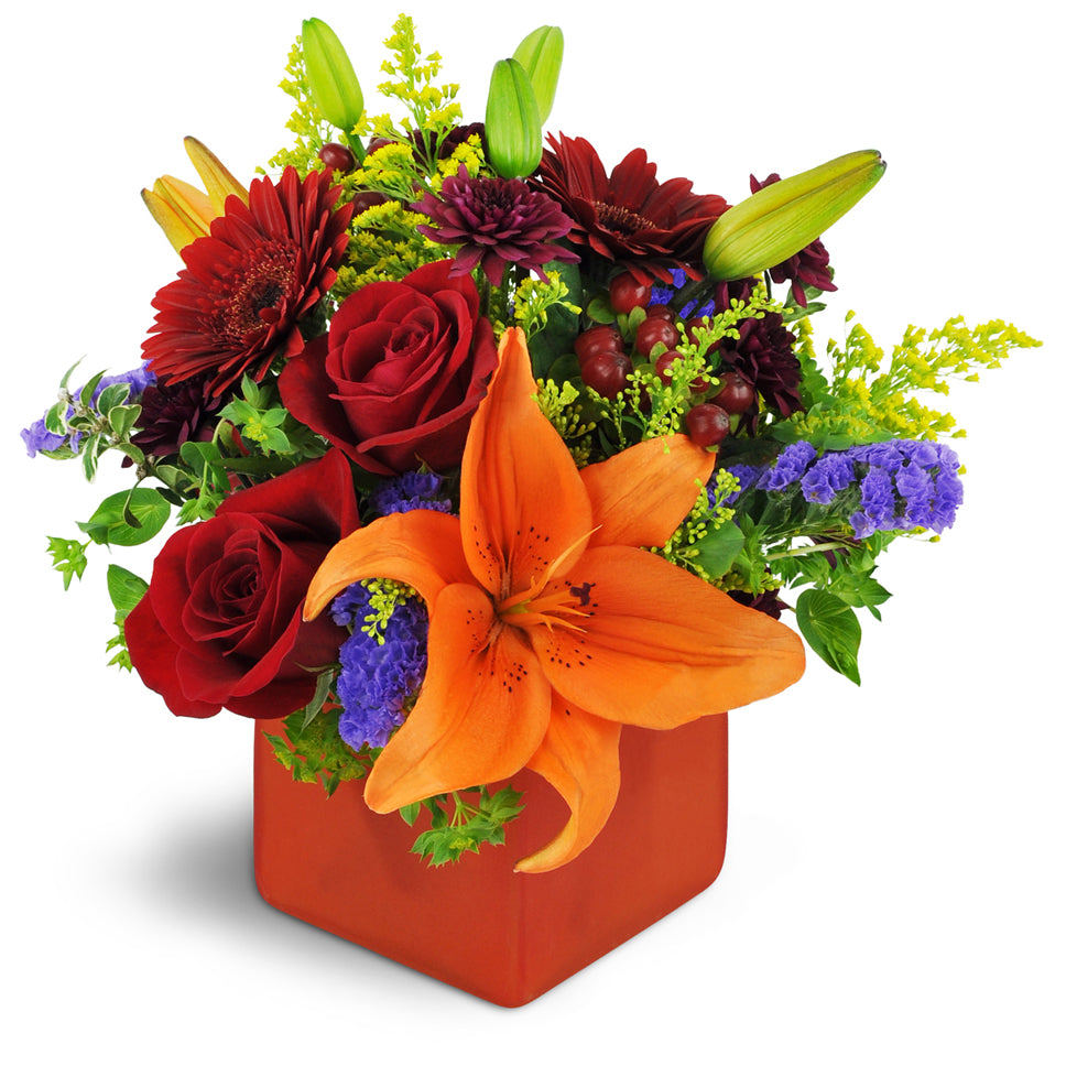 Fruit of the Bloom™ - Deluxe. A colorful mix of mini Gerbera daisies, Asiatic lilies, and chrysanthemums are accented with bupleurum, hypericum berries, purple statice, and orange waxflower.