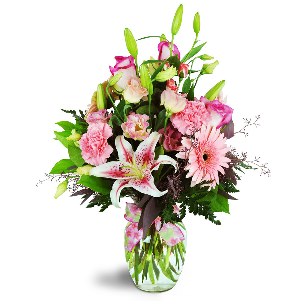 Daisy Day Blush™. Delight them with Gerbera daisies, Stargazer lilies, and more arranged in a classic vase.