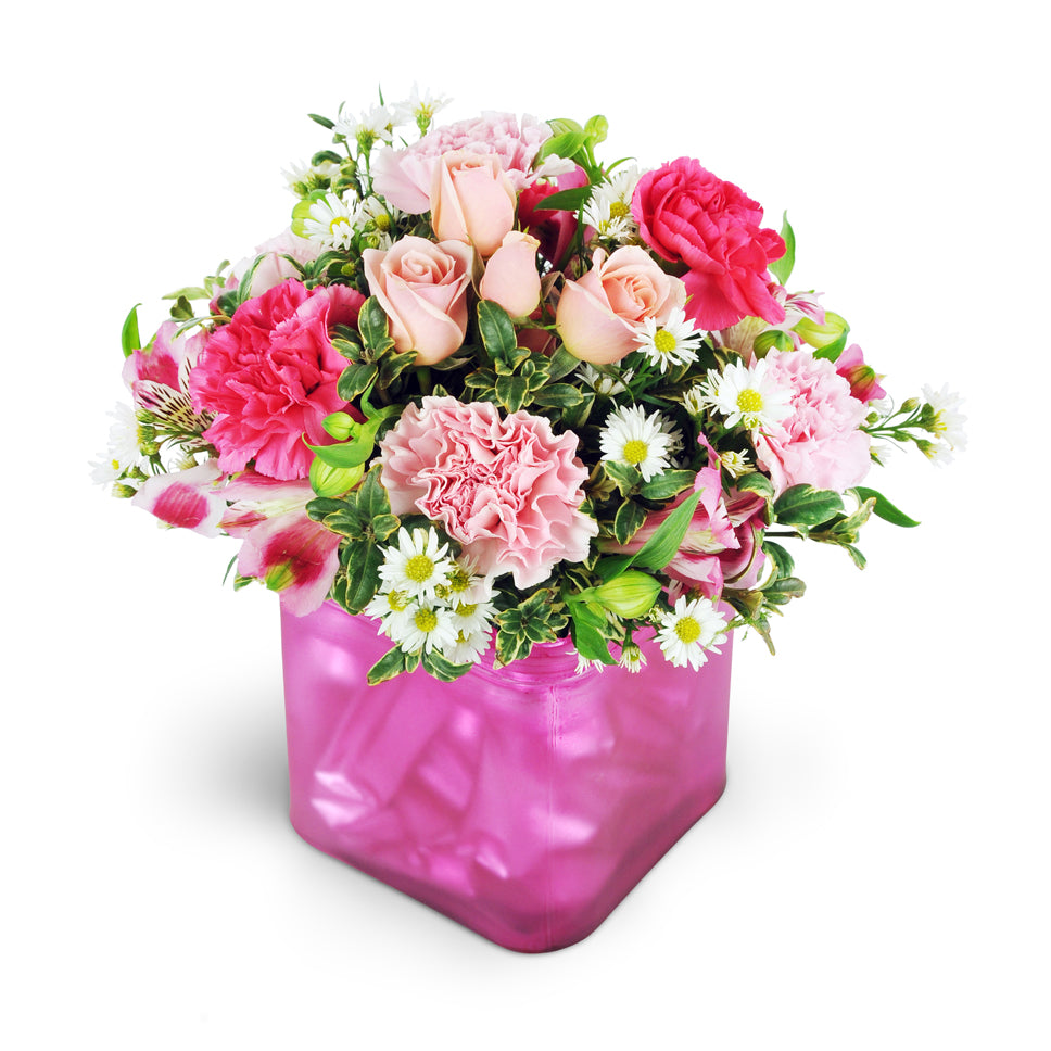 Sweet Sentiments. Pink and fuchsia carnation, sweet pink spray roses, pink alstroemeria, and white asters are arranged in a pretty pink vase.