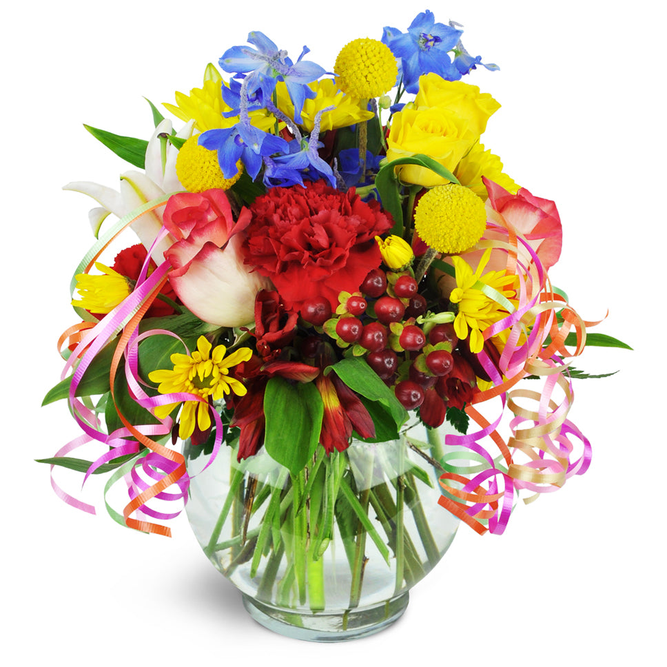 Celebrating You!™ - Standard. Roses, carnations, lilies, and more are arranged in a glass vase.