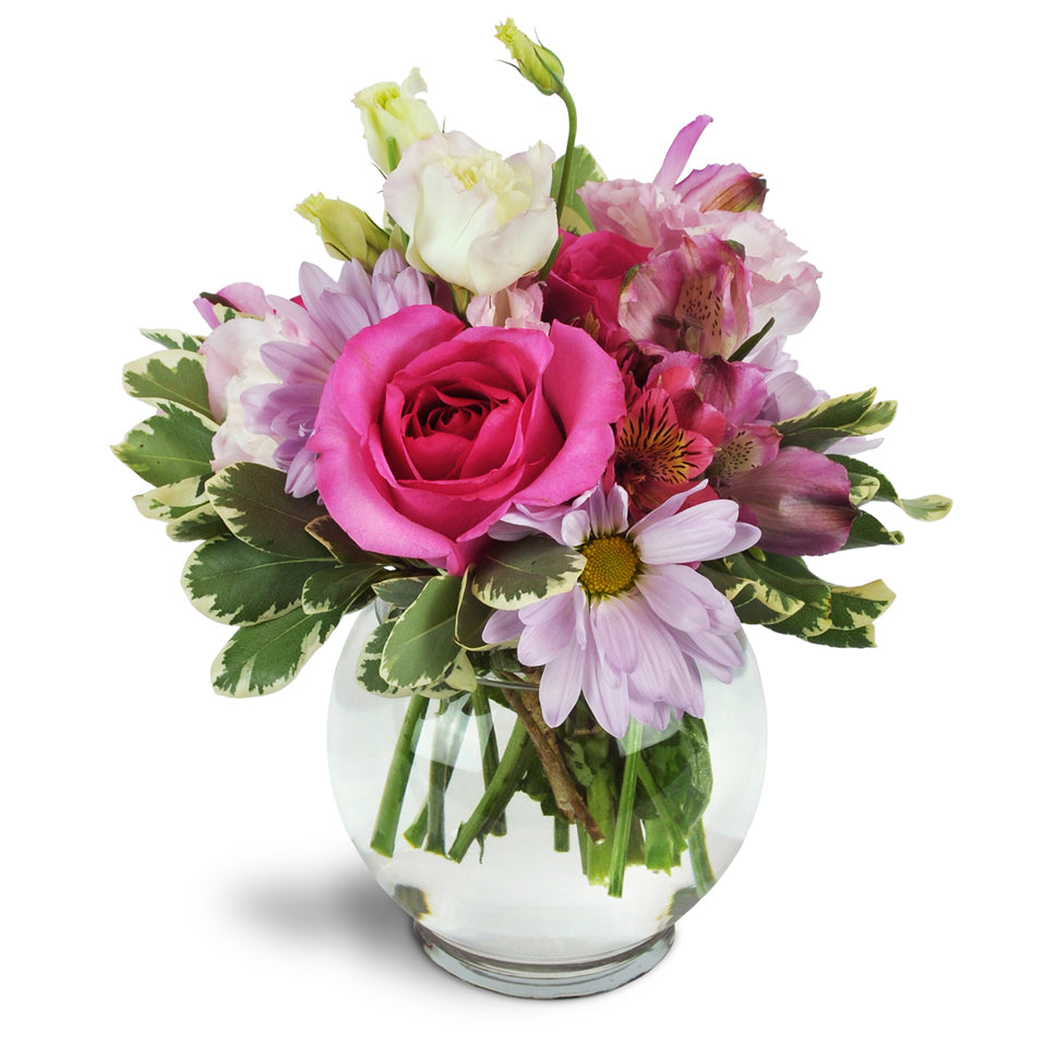 Fondly Fuchsia™. Roses, daisies, lisianthus, and more are beautifully arranged in a clear bubble bowl.