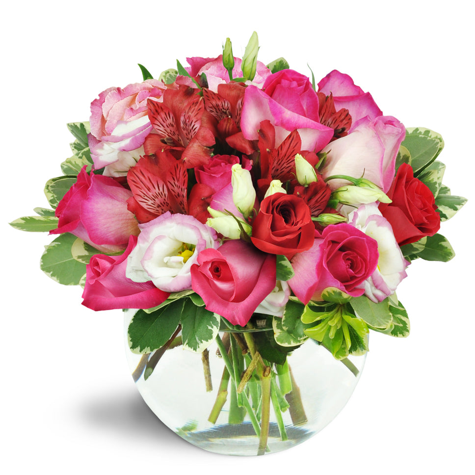 Cupid's Arrow™ - Premium. Pink roses, creamy lisianthus, lush red alstroemeria, and more burst from a charming bubble bowl vase.