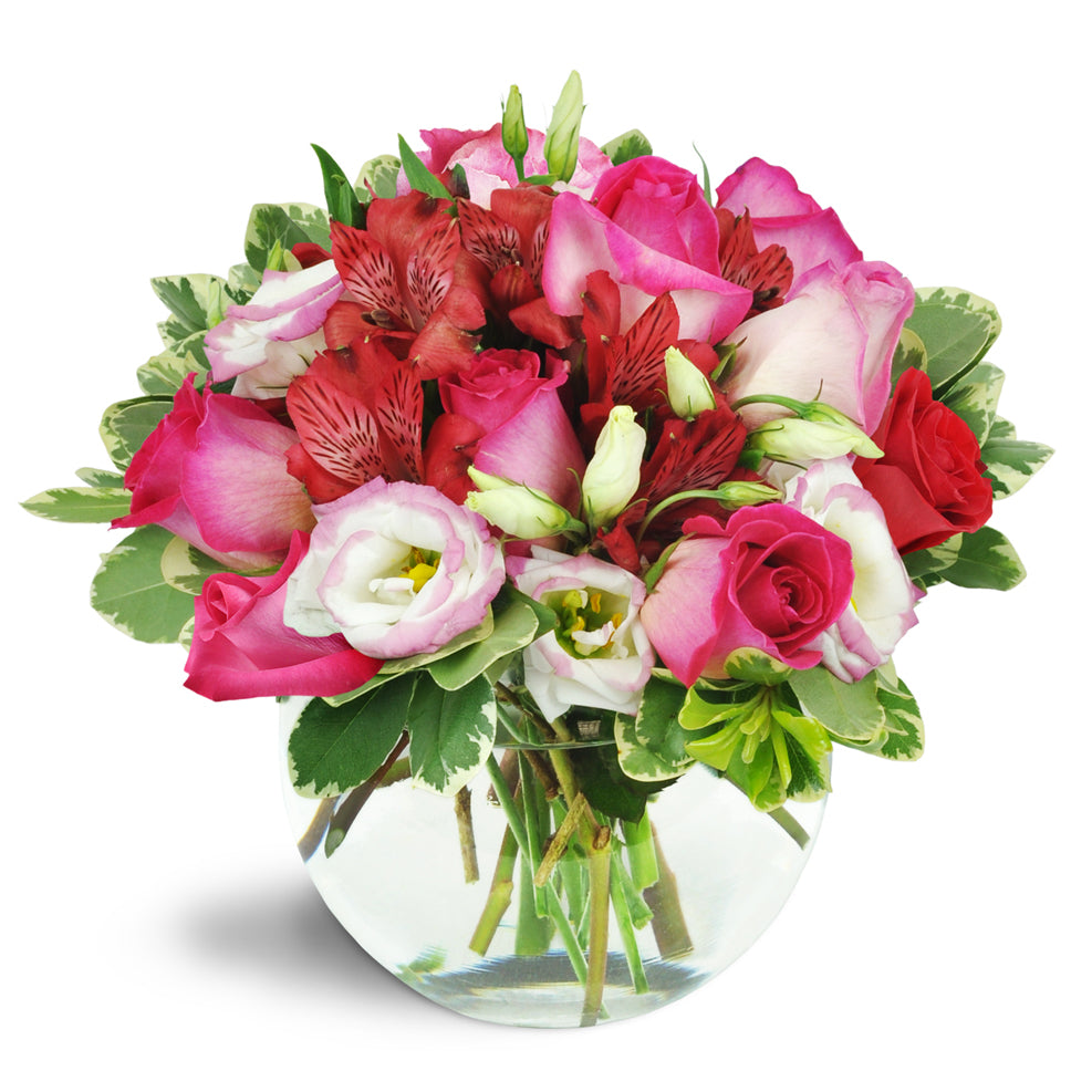 Cupid's Arrow™ - Deluxe. Pink roses, creamy lisianthus, lush red alstroemeria, and more burst from a charming bubble bowl vase.