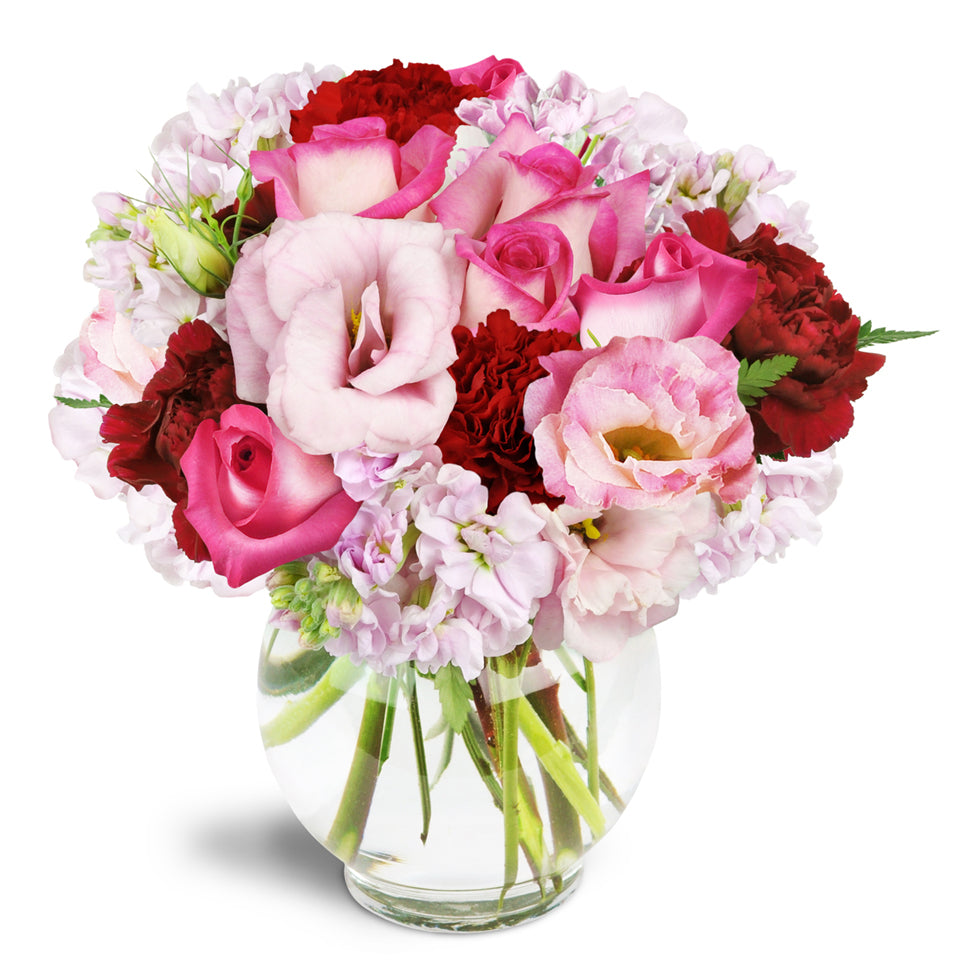 Joyful Heart™ - Premium. Bring joy to all with pink roses, lisianthus, stock, and red carnations.