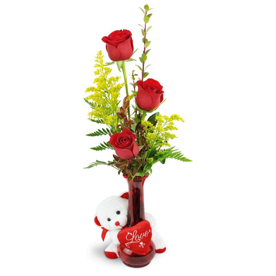 Rose Trio™ with Love Bear. Three red roses are arranged with greenery and encircled by a white plush bear.