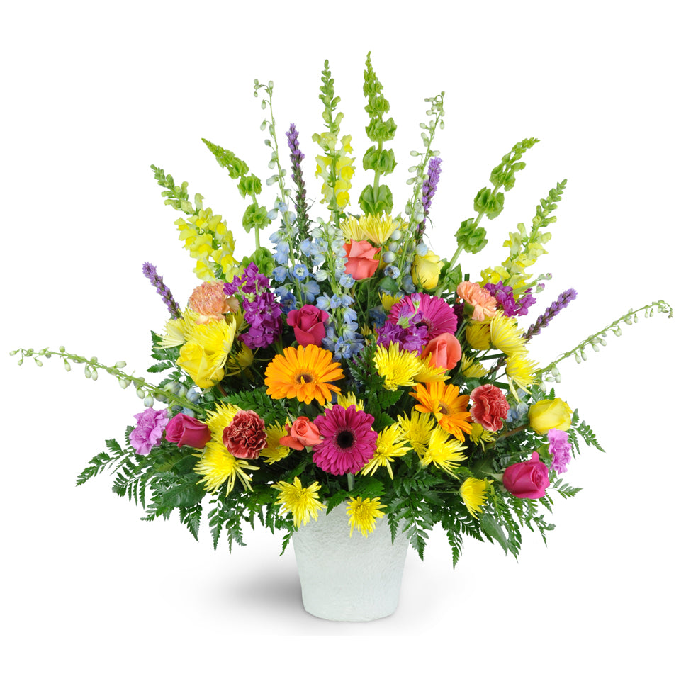 Bright Memories flower arrangement. A vibrant mixture of Gerbera daisies, snapdragons, fuji poms, roses, and more.