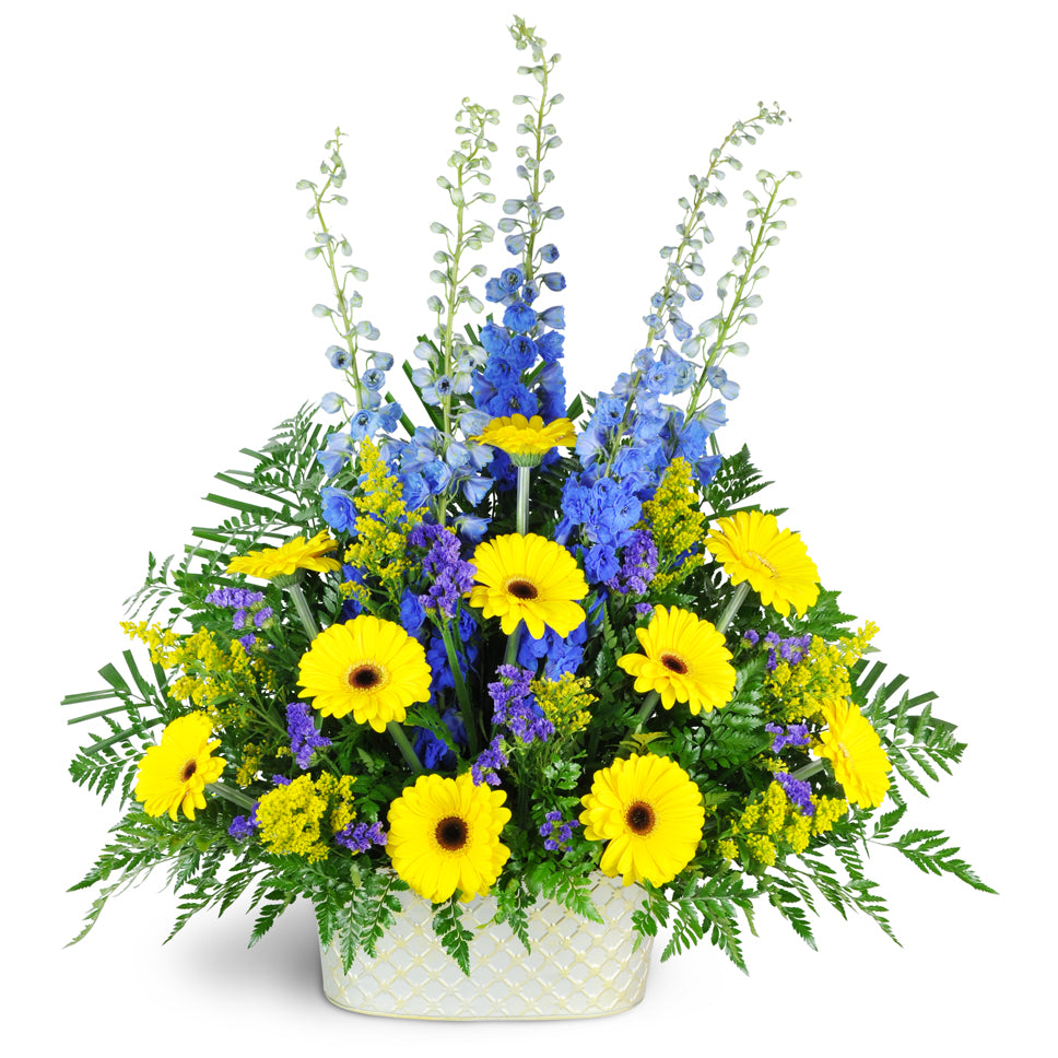 Joyful Memories. This uplifting mix of delphinium, yellow Gerbera, solidago, statice, and more can be sent to the service or funeral home.