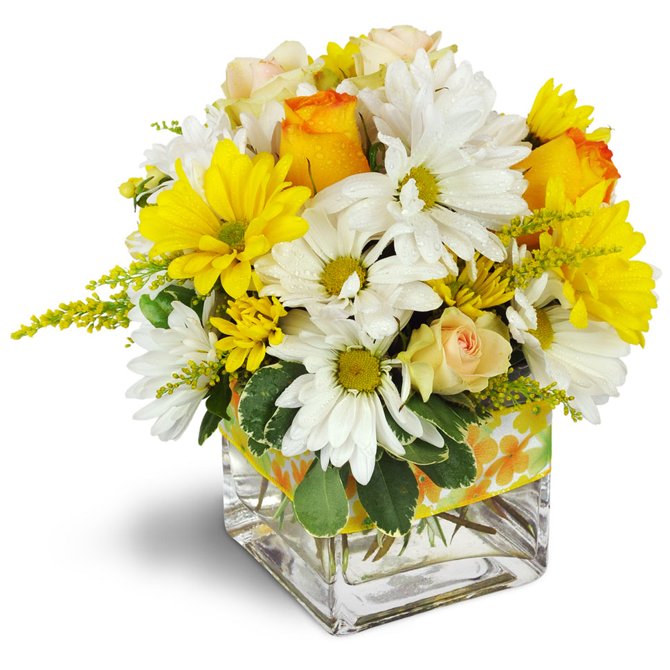 Sunshine Medley™. Yellow and white daisies are beautifully accented with light pink spray roses and orange roses.