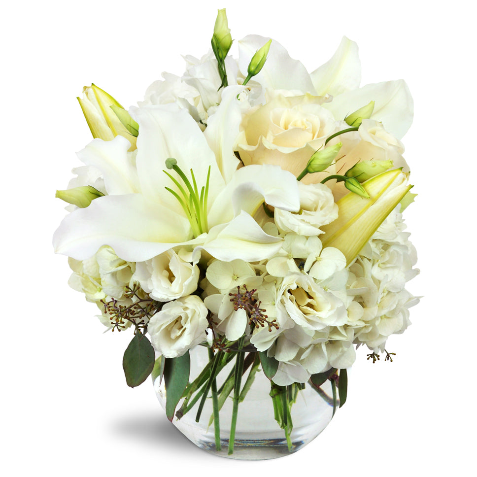 Halcyon Heart™ - Premium. A beautiful all-white arrangement including lilies, roses, lisianthus, and more.