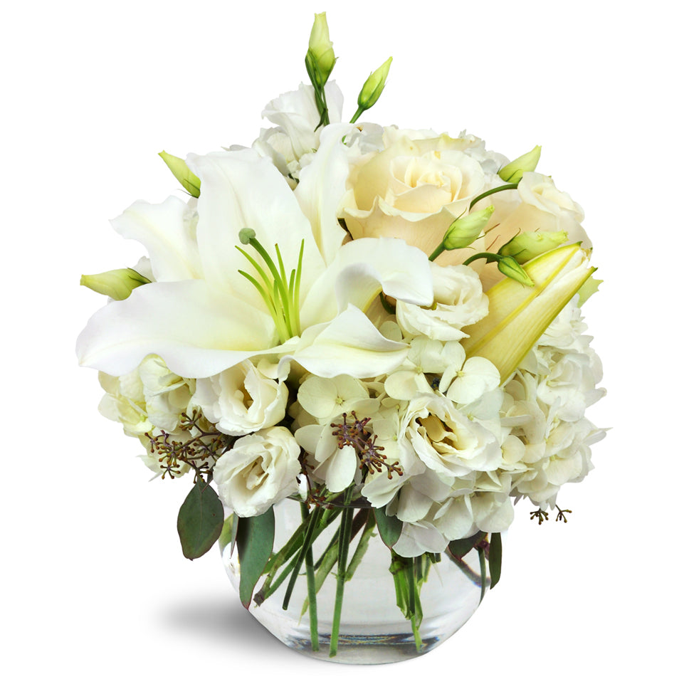 Halcyon Heart™ - Deluxe. A beautiful all-white arrangement including lilies, roses, lisianthus, and more.