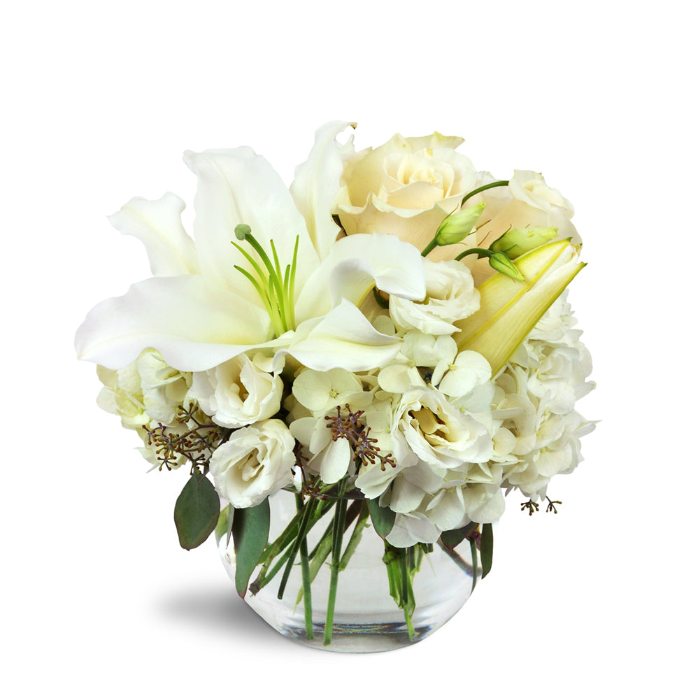 Halcyon Heart™ - Standard. A beautiful all-white arrangement including lilies, roses, lisianthus, and more.