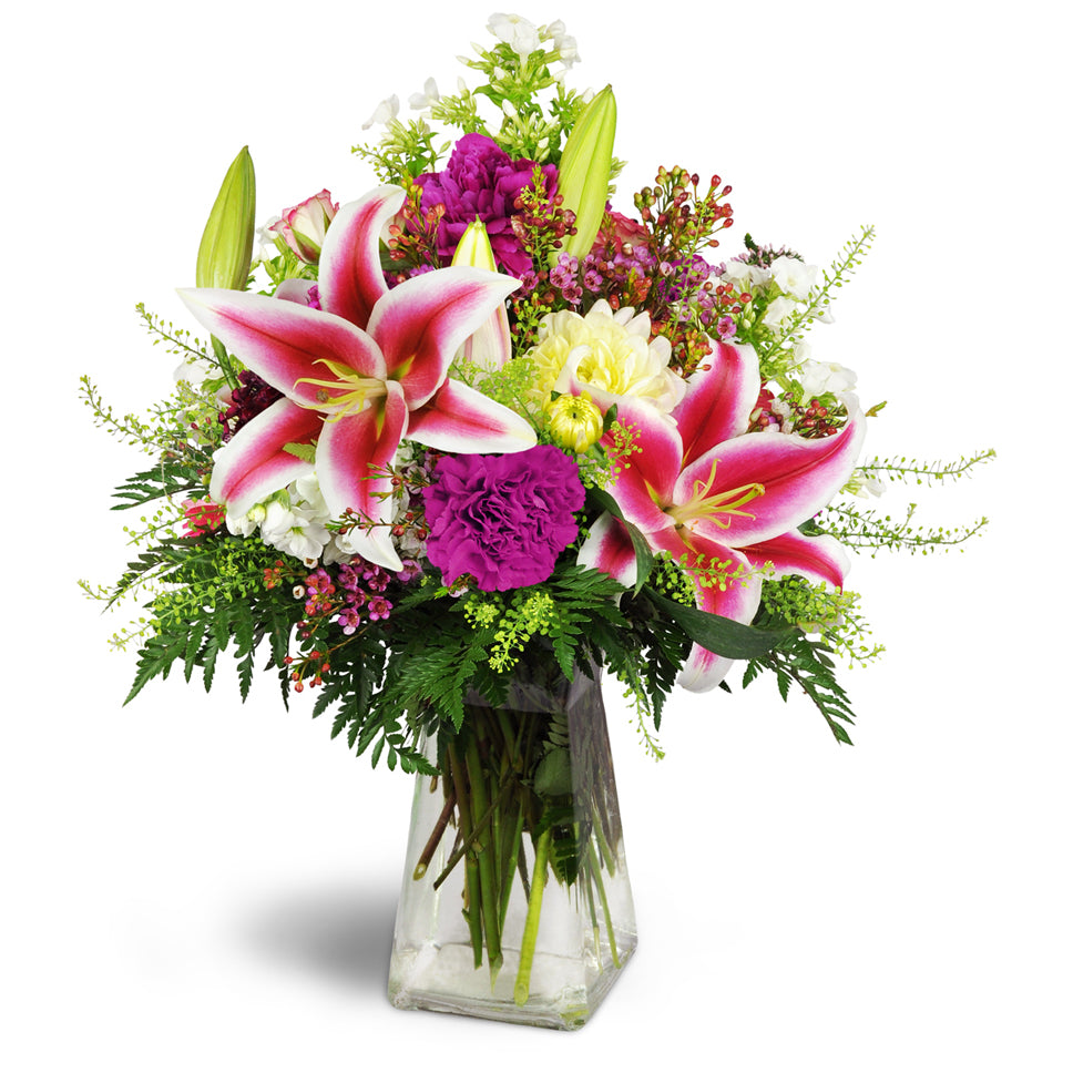 Spring’s Bounty Bouquet™ - Deluxe. Gift them a lovely bouquet filled with Stargazer lilies, dahlias, and seasonal blooms arranged in a pretty glass vase.