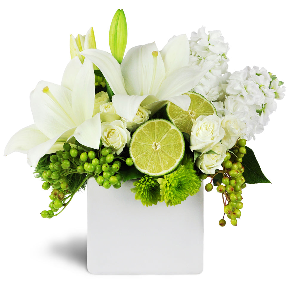 Citrus Breezes™. Delight them with white lilies, spray roses, and more accented with cut limes.