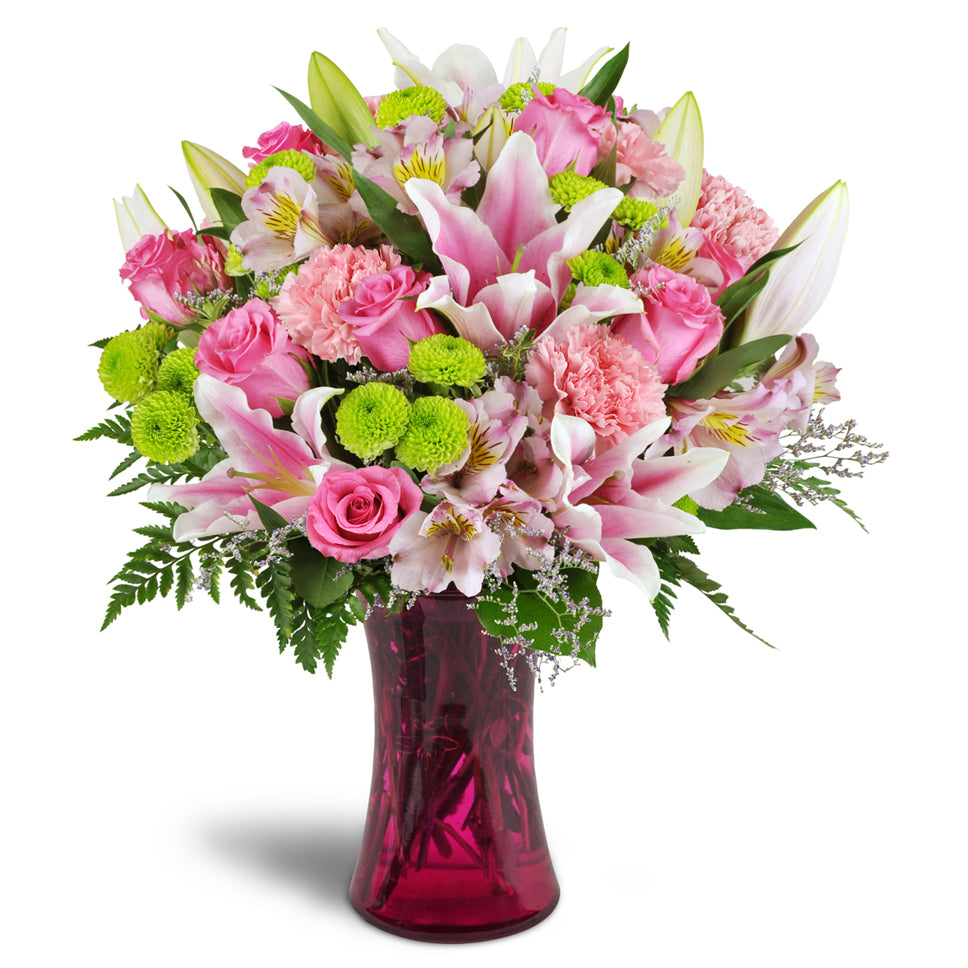 Perfectly Pink™ - Premium. Your arrangement will include bright pink roses, carnations, and alstroemeria, plus lime green poms for added charm.