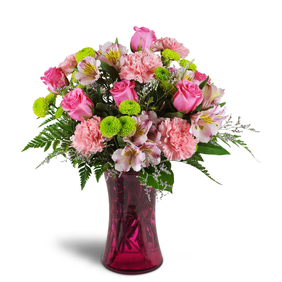 Perfectly Pink™ - Standard. Your arrangement will include bright pink roses, carnations, and alstroemeria, plus lime green poms for added charm.