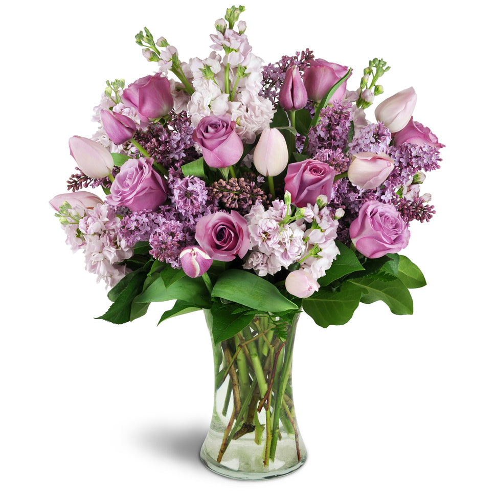 Fragrance Bouquet for Spring™ - Premium. Send them lovely lilacs, stock, tulips, and roses elegantly arranged in a glass vase.