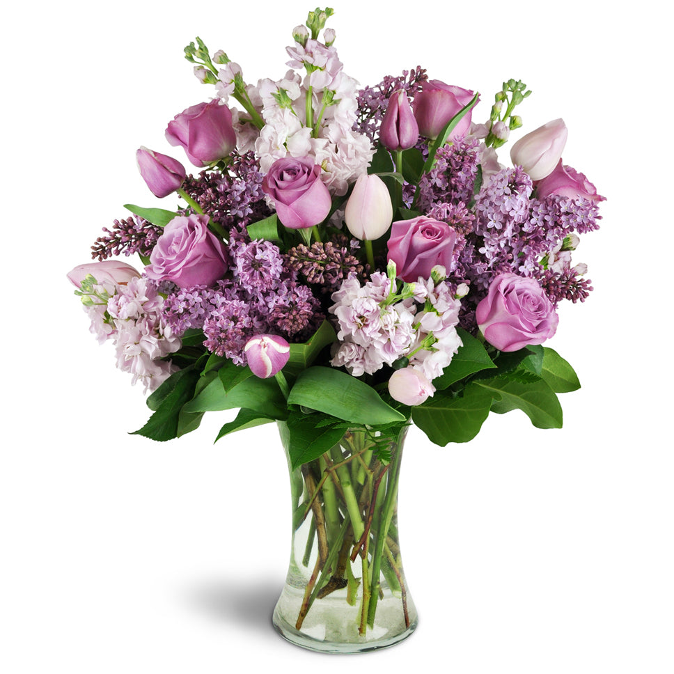 Fragrance Bouquet for Spring™ - Deluxe. Send them lovely lilacs, stock, tulips, and roses elegantly arranged in a glass vase.