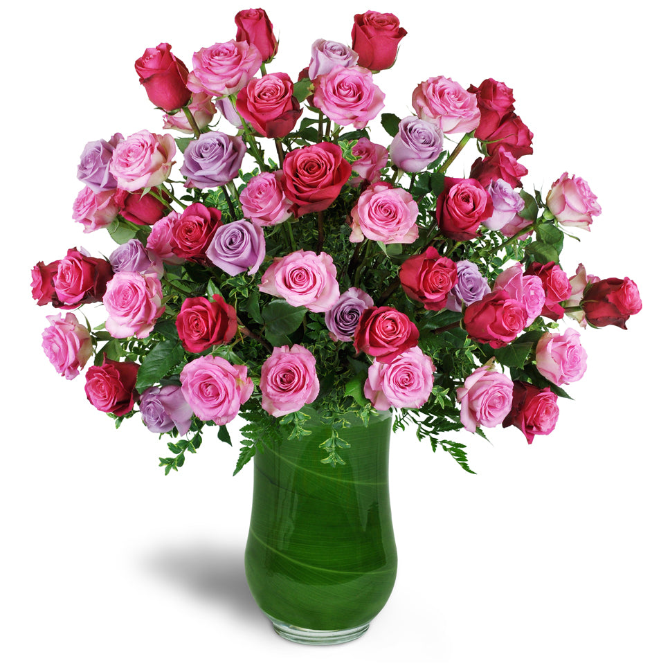 Infinite Love Roses™. Five dozen premium roses in fuchsia, pink, and lavender are expertly arranged in a clear vase.