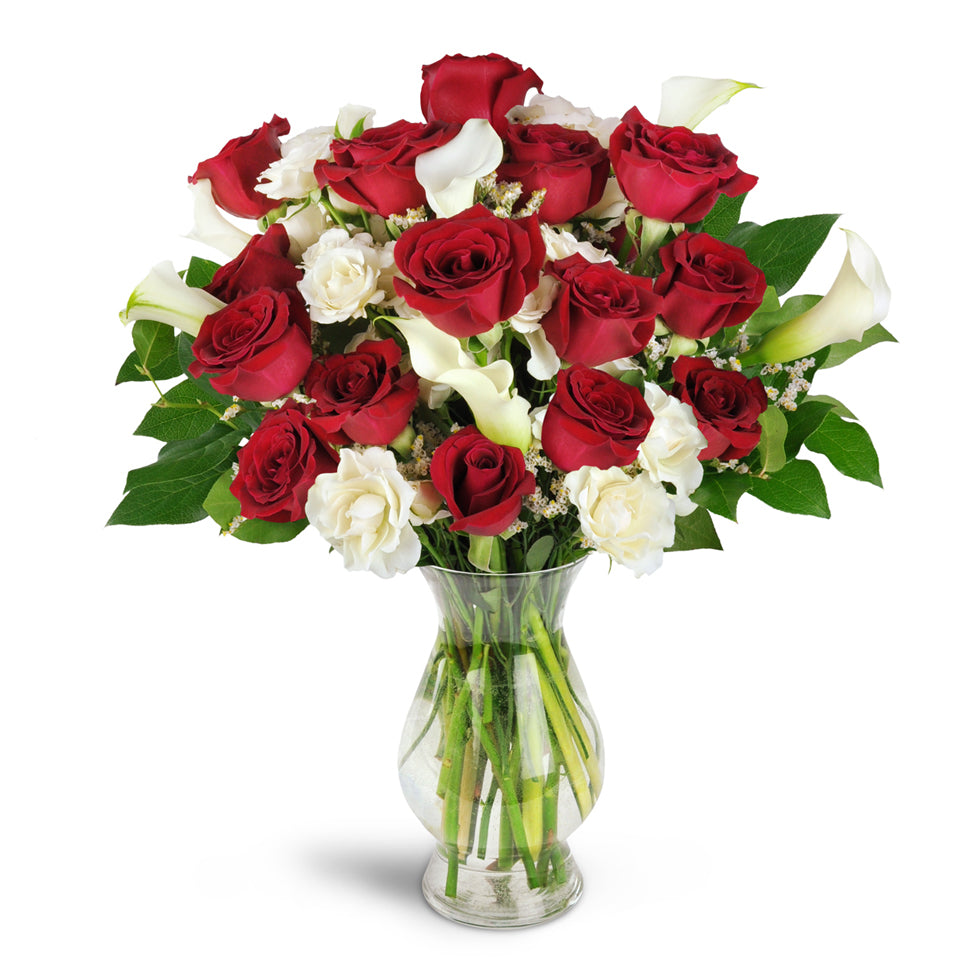 Love You Forever™ Bouquet - Premium. A dozen red roses are arranged with white spray roses, lush mini calla lilies, and more.