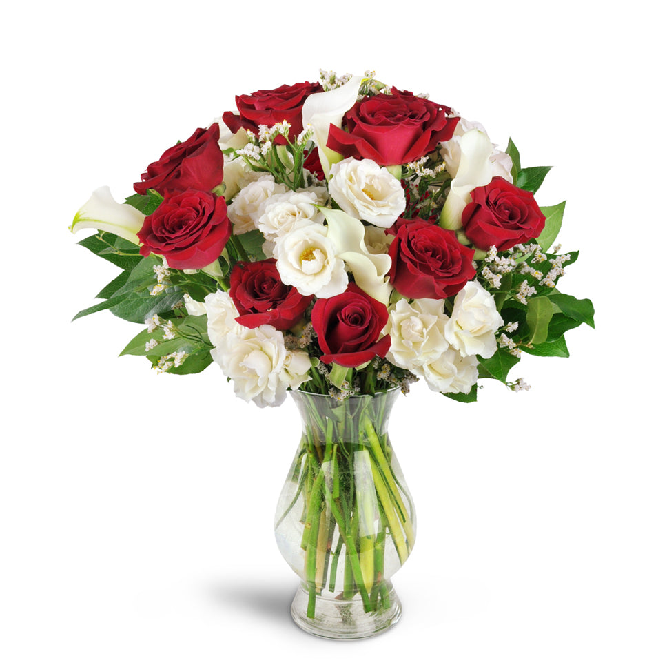 Love You Forever™ Bouquet - Standard. A dozen red roses are arranged with white spray roses, lush mini calla lilies, and more.