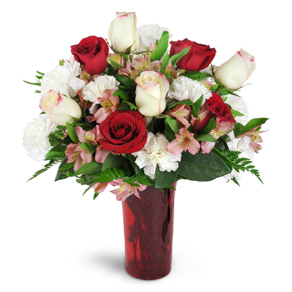 Romance of Roses™ - Deluxe. Give a stunning gift of red and cream roses arranged with carnations, alstroemeria, and more.