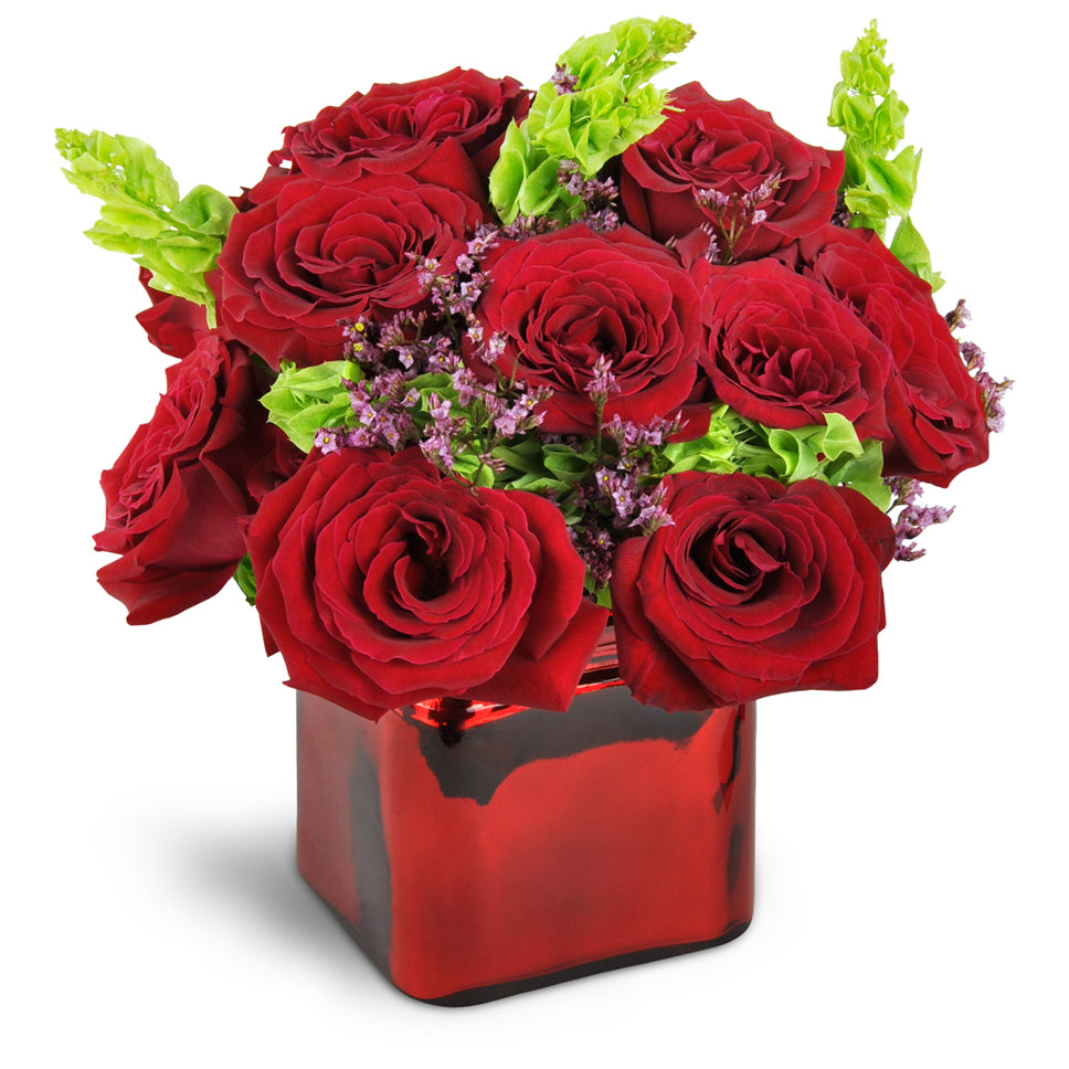 Kiss of Bliss™. Lush red roses are beautifully accented with Bells of Ireland and limonium.