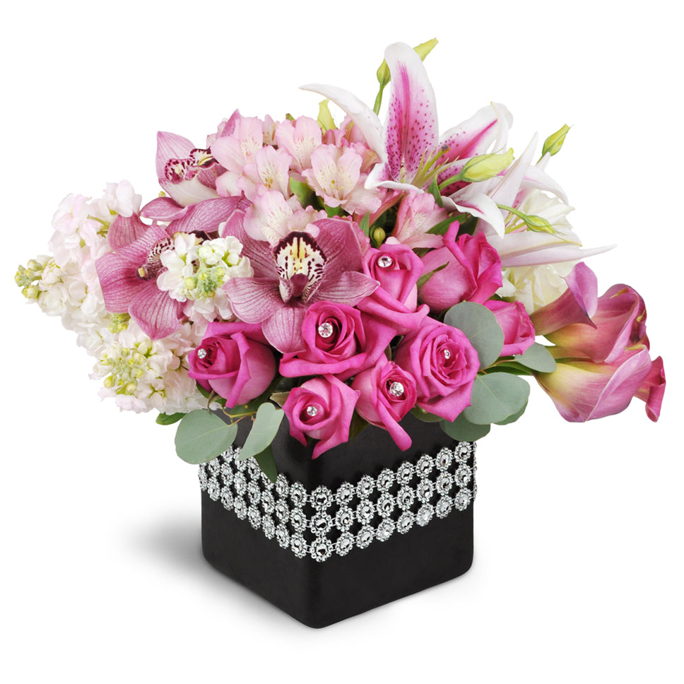 Forever and Always™ Bouquet - Premium. Pink roses and mini Calla lilies are arranged with an abundance of pink blooms in a ceramic container. Upgrade to Deluxe to add Stargazer lilies or Premium to add Stargazer lilies and Cymbidium orchids.