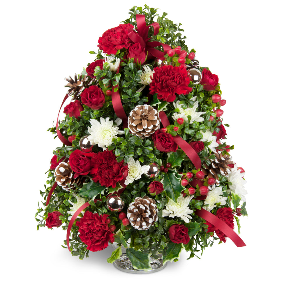 Celebration Flower Tree™ - Premium. Boxwood, holly, and more are accented with fresh blooms and cheerful ribbon.