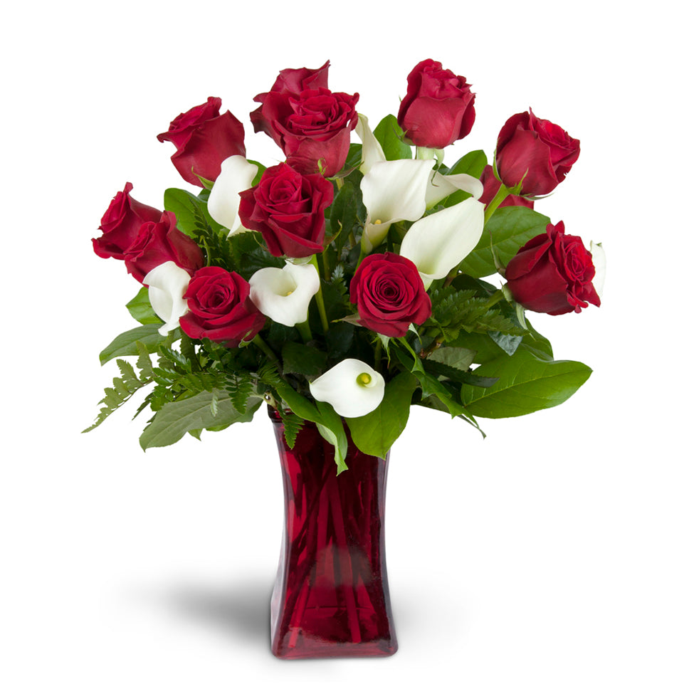 Full of Love™ - Standard. Classic red roses and mini Calla lilies are elegantly arranged in a glass vase. Upgrade to Premium to add large, fragrant lilies.