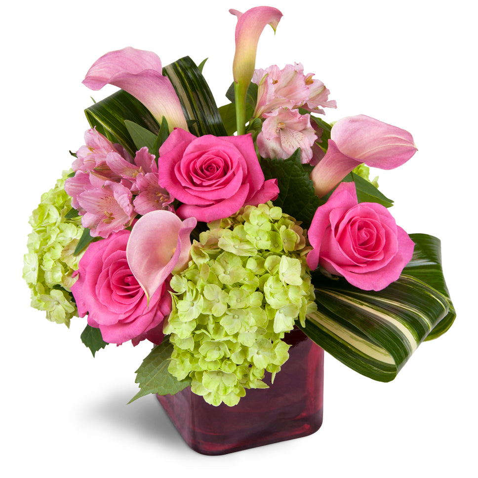 Peek of Chic™ - Premium. Hot-pink roses, green hydrangea, and pink Peruvian lilies are accented with fresh aspidistra.