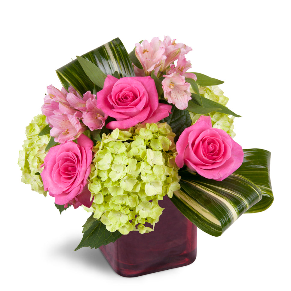 Peek of Chic™ - Standard. Hot-pink roses, green hydrangea, and pink Peruvian lilies are accented with fresh aspidistra.