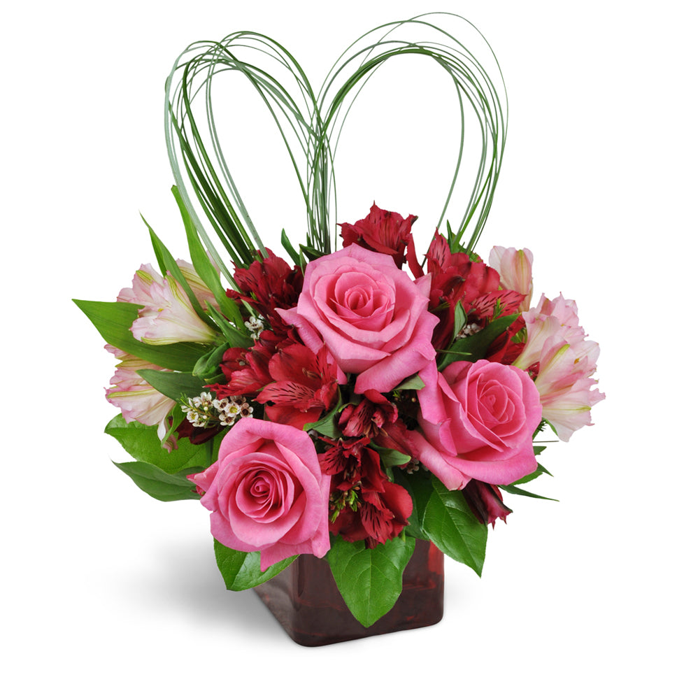 With All My Heart™ Bouquet - Premium. Romantic Peruvian lilies and waxflower are perfectly accented with heart-shaped beargrass. Upgrade to Deluxe or Premium to add stunning pink roses.