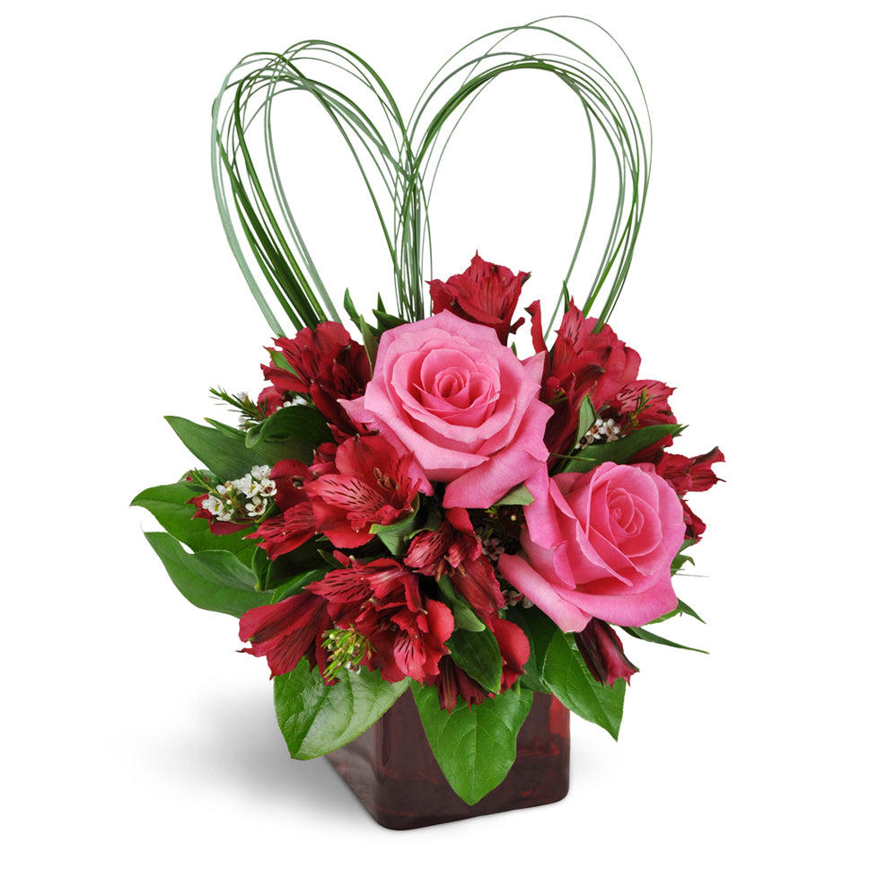 With All My Heart™ Bouquet - Deluxe. Romantic Peruvian lilies and waxflower are perfectly accented with heart-shaped beargrass. Upgrade to Deluxe or Premium to add stunning pink roses.