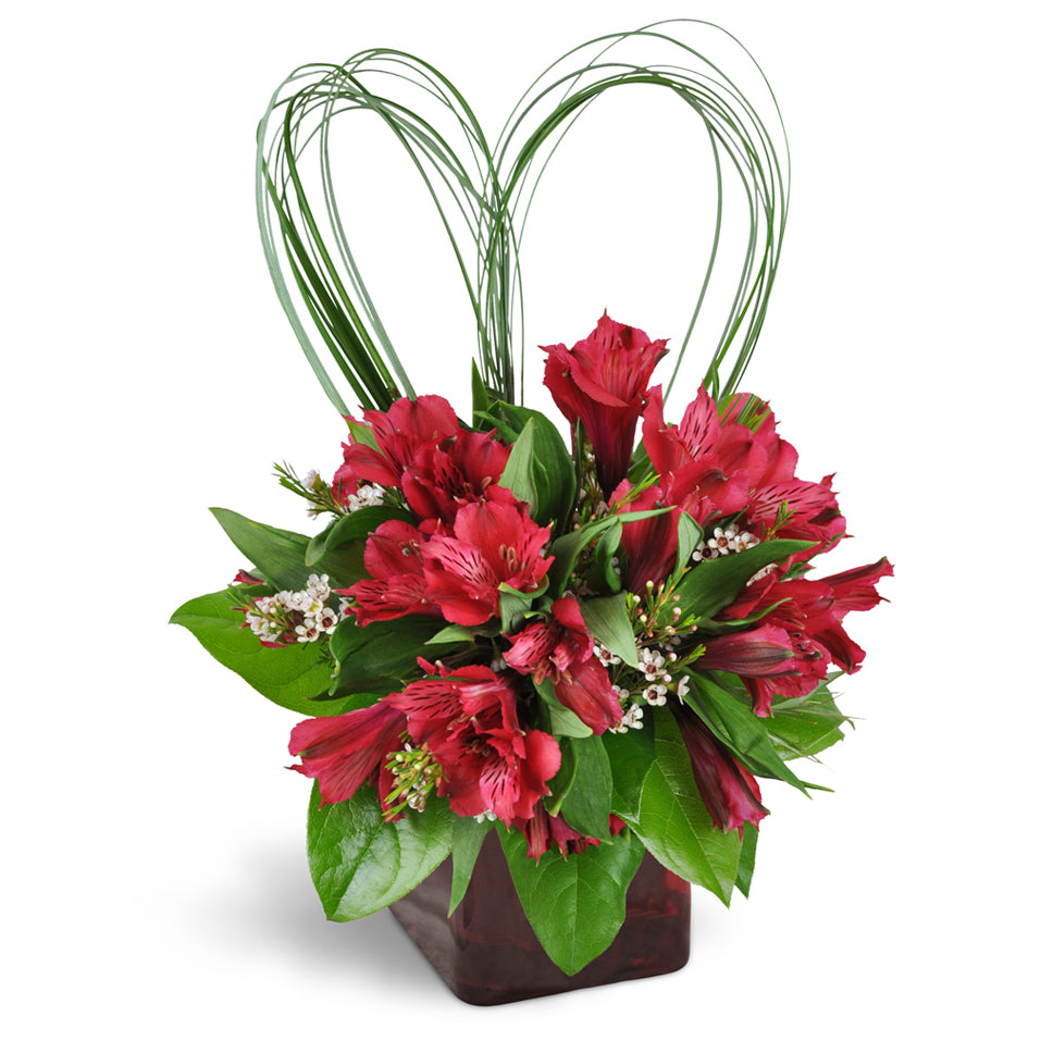 With All My Heart™ Bouquet - Standard. Romantic Peruvian lilies and waxflower are perfectly accented with heart-shaped beargrass. Upgrade to Deluxe or Premium to add stunning pink roses.