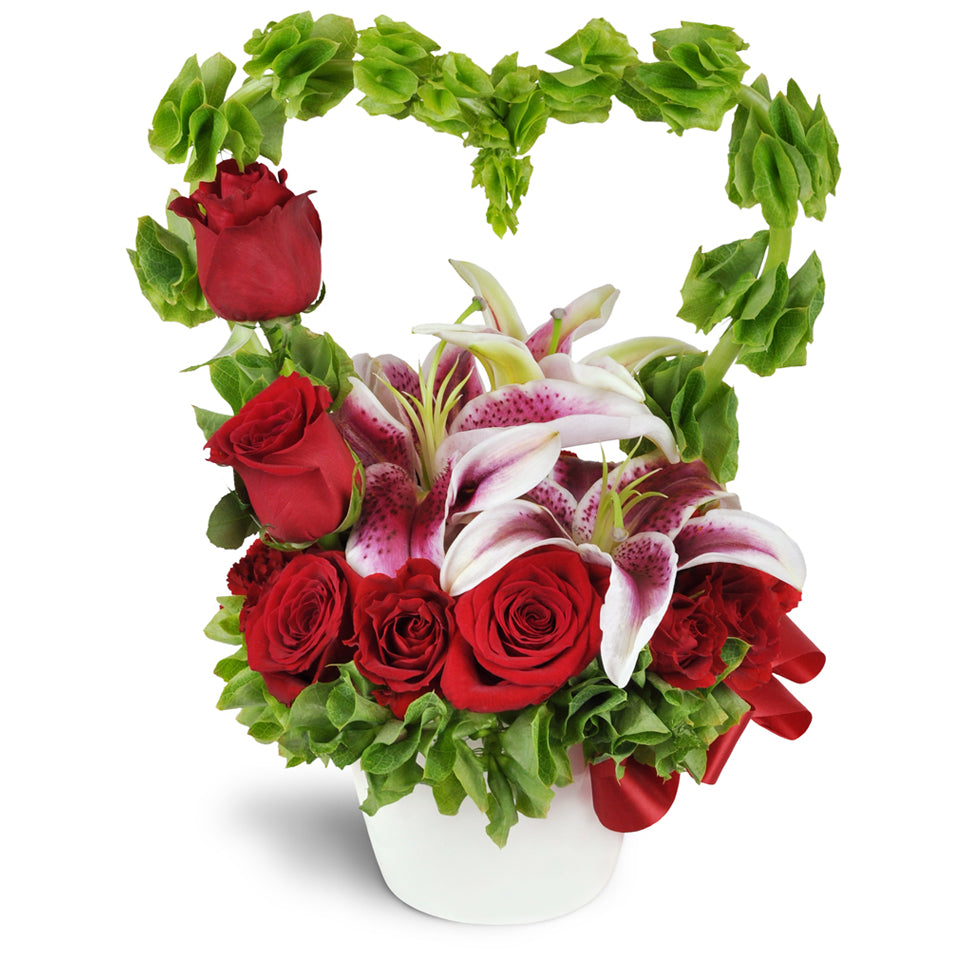 My Love Grows Bouquet™ - Premium. Stargazer lilies are encircled by a romantic heart-shaped arc of Bells of Ireland and accented with spray roses and more. Upgrade to Premium to add luxurious red roses.