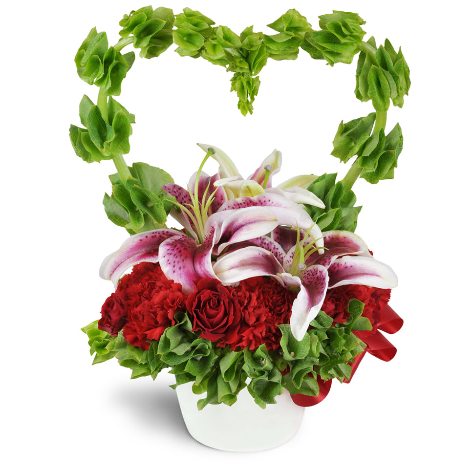 My Love Grows Bouquet™ - Standard. Stargazer lilies are encircled by a romantic heart-shaped arc of Bells of Ireland and accented with spray roses and more. Upgrade to Premium to add luxurious red roses.