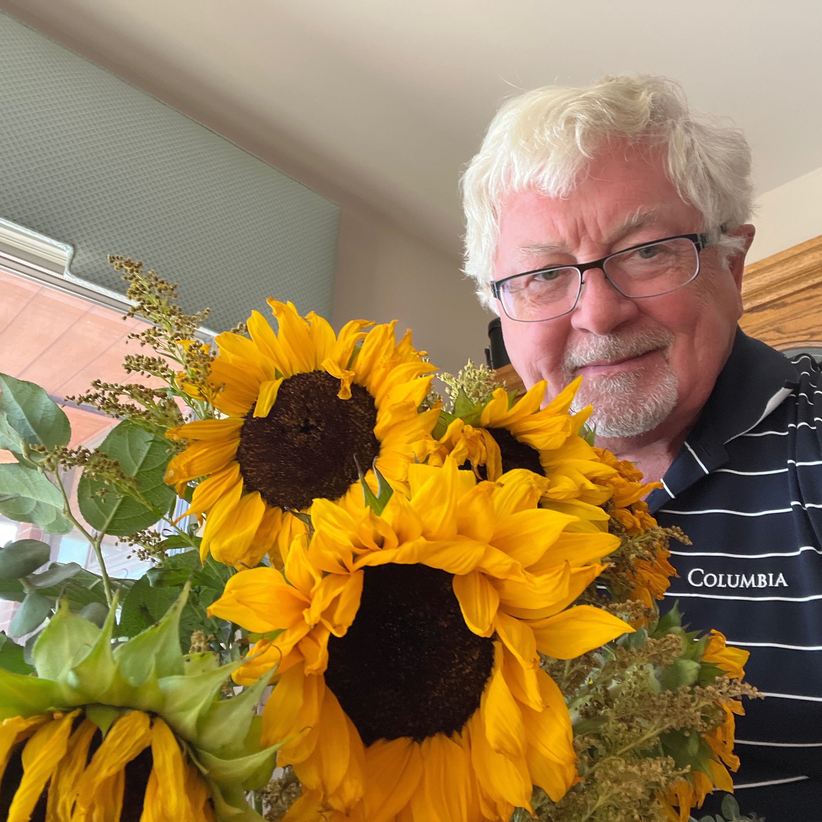 A heartfelt thanks for Armful of Sunshine. Gentleman holding bouquet of flowers with a smile.