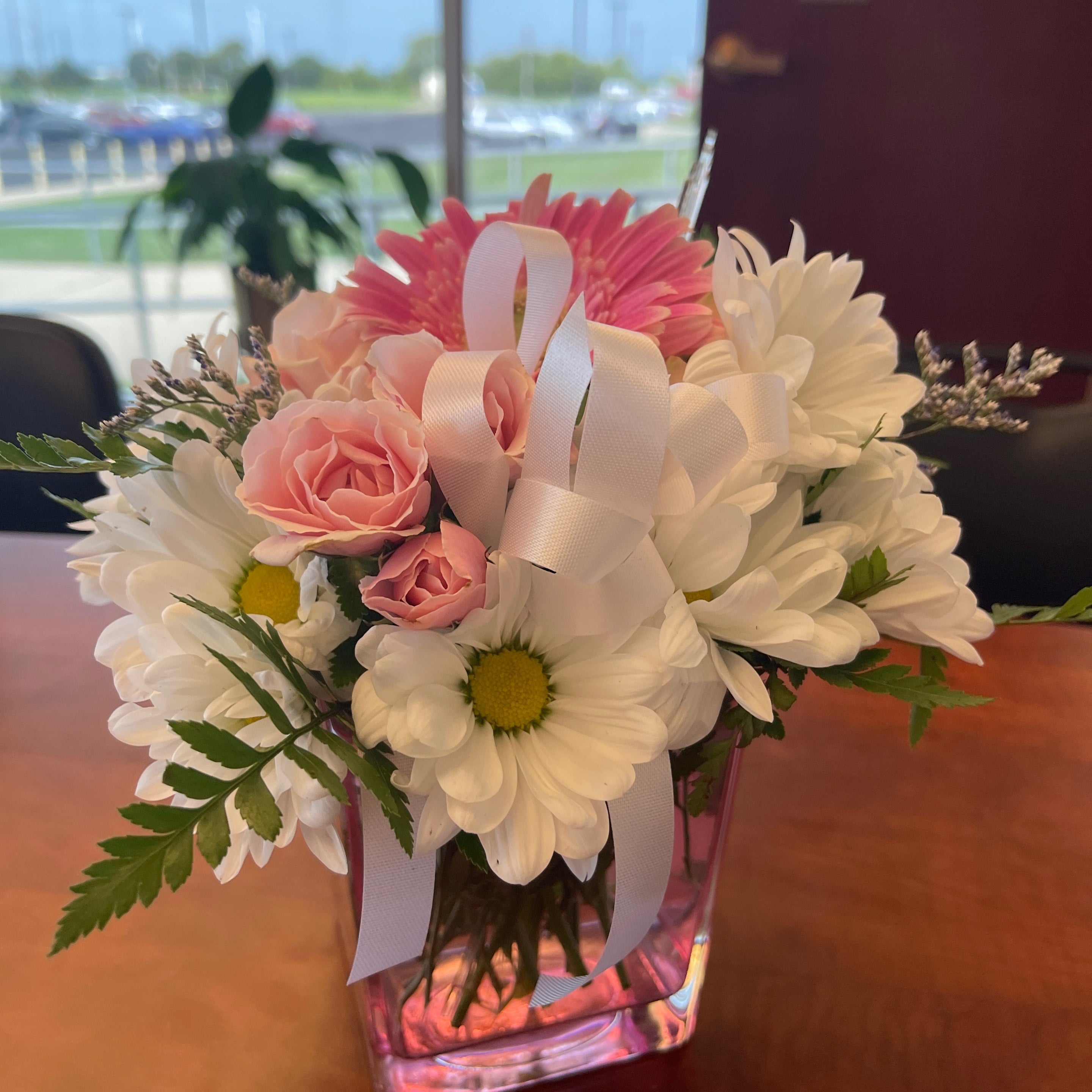 A heartfelt thanks for Bubble Gum Bliss flowers on a table with a window in the background.