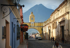 Guatemalan street with buildings and view of mountain