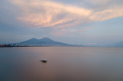 Ocean with boat and distant volcano