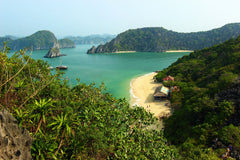 Blue lagoon with beach and rocky headland