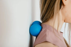 Small massage balls located on the traps (between shoulders)