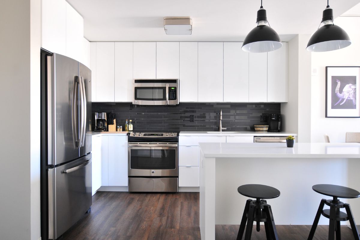 A stylish kitchen with an oven and refrigerator on display