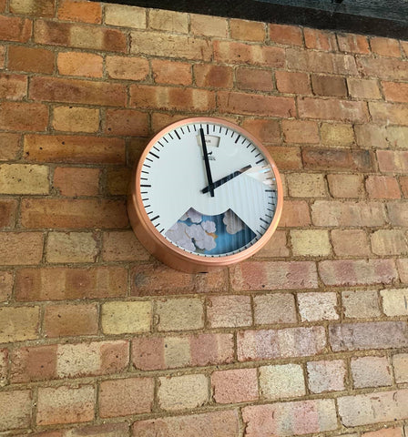 Clock on brick wall in holiday home