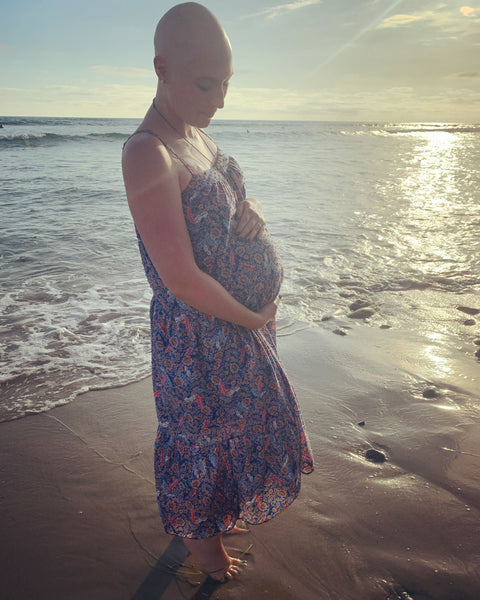 Amy standing at the beach while pregnant